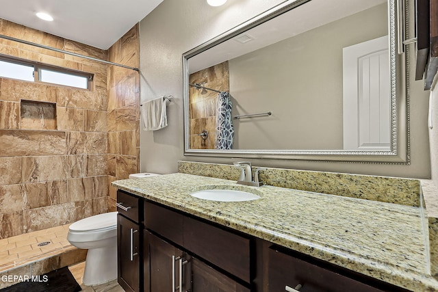 bathroom with vanity, walk in shower, and toilet