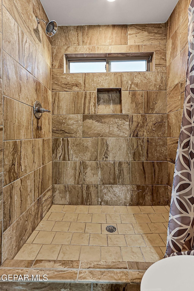 bathroom featuring toilet and walk in shower