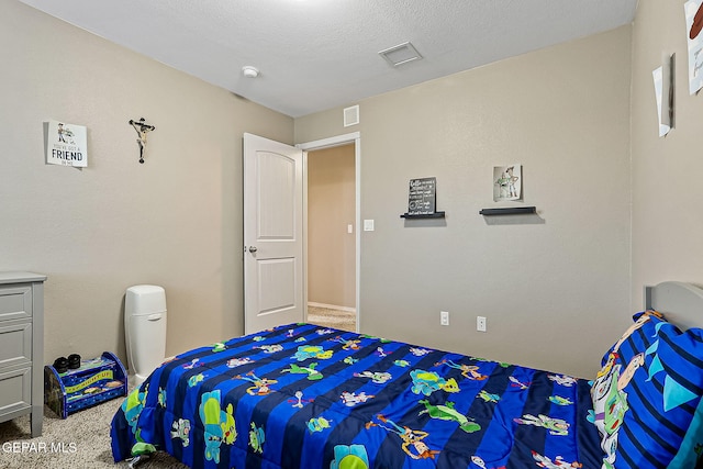 carpeted bedroom with a textured ceiling