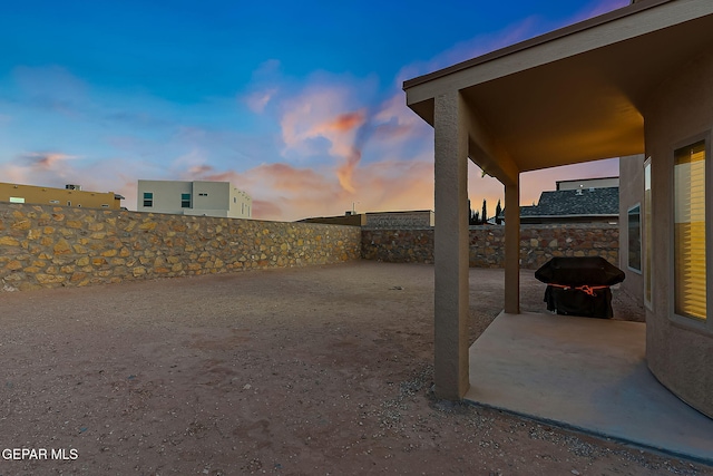 yard at dusk with a patio area