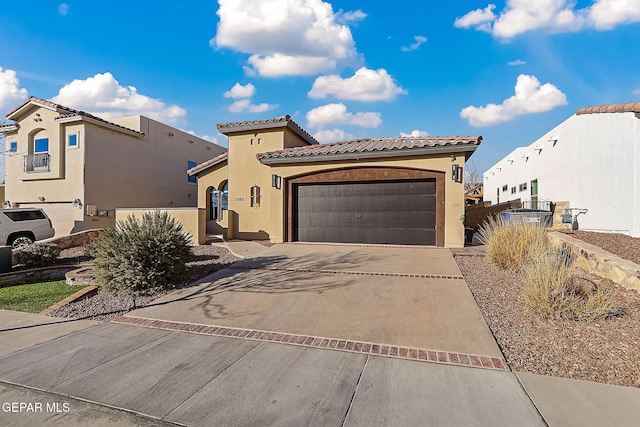 mediterranean / spanish-style home with a garage