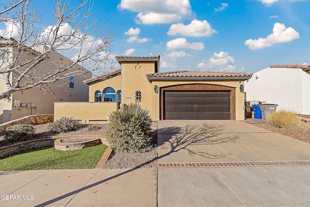 mediterranean / spanish home with a garage