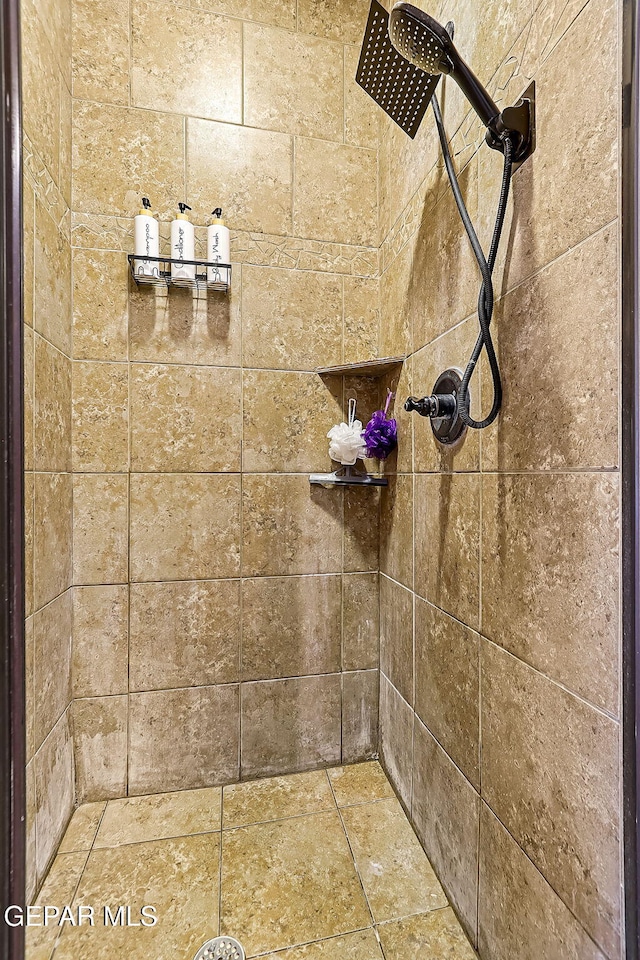 bathroom with a tile shower