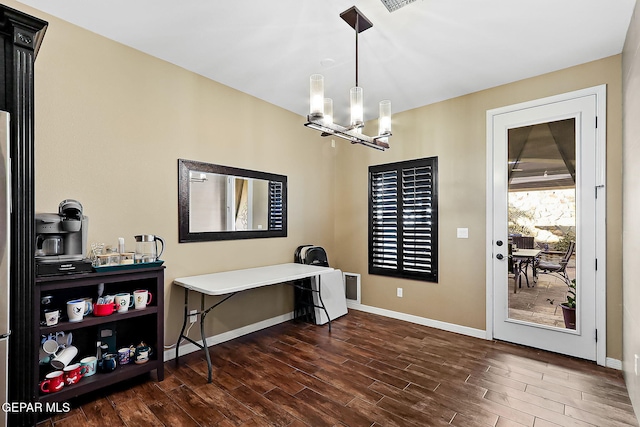 office area with a notable chandelier and dark wood-type flooring