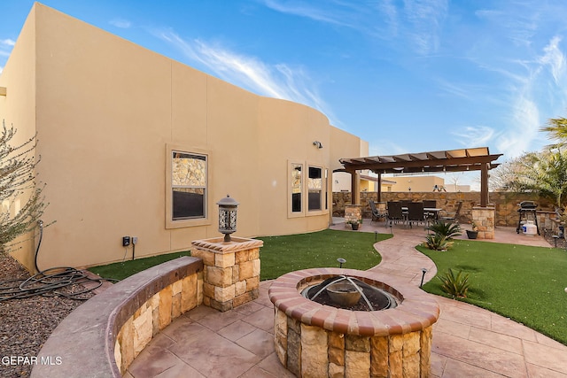 back of property featuring an outdoor fire pit, a patio, a yard, and a pergola