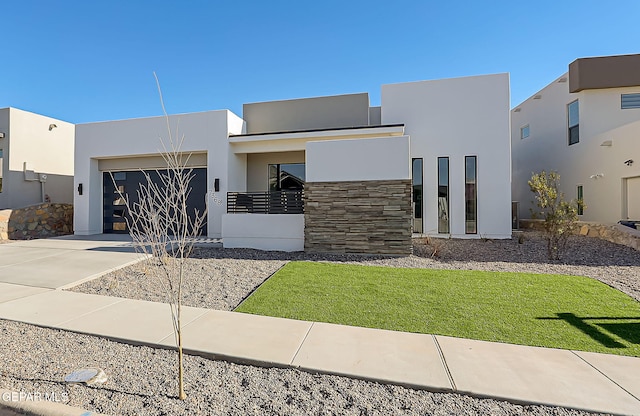 modern home featuring a garage and a front lawn