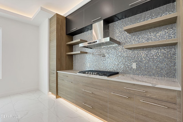 kitchen with stainless steel gas cooktop, decorative backsplash, and wall chimney exhaust hood