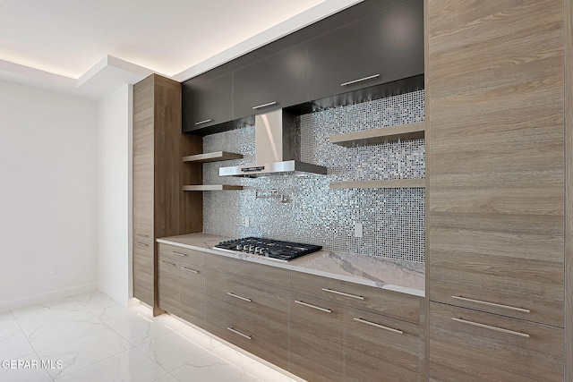 kitchen featuring tasteful backsplash, wall chimney exhaust hood, and stainless steel gas stovetop