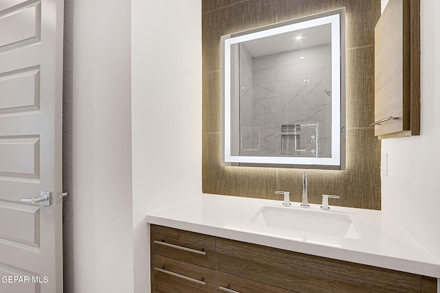 bathroom featuring vanity and tiled shower