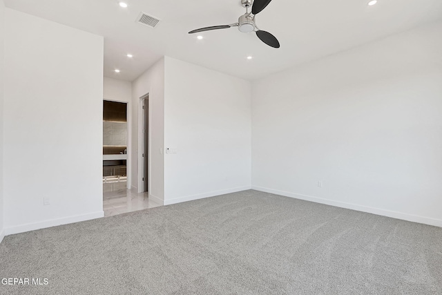 unfurnished room featuring ceiling fan and light colored carpet