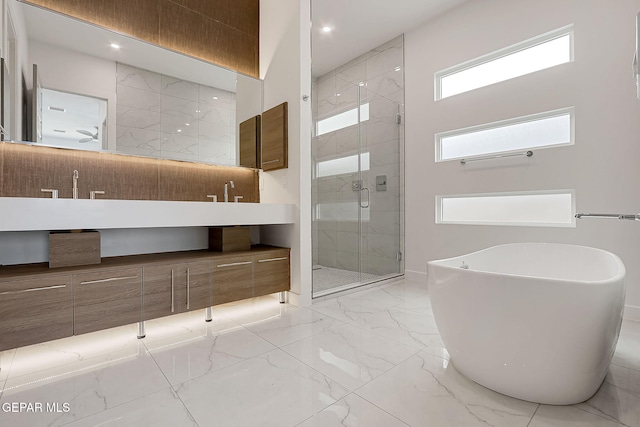 bathroom with vanity and independent shower and bath