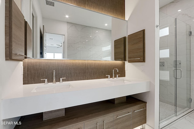 bathroom featuring vanity and a shower with shower door