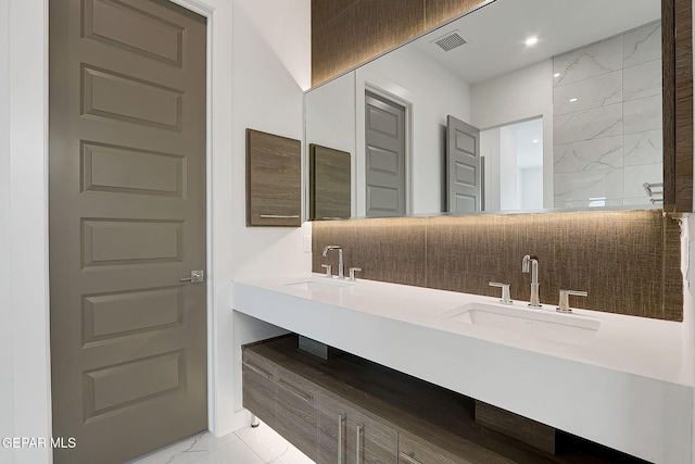 bathroom with tasteful backsplash and vanity