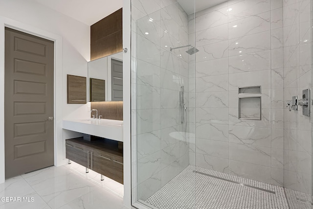 bathroom with vanity and tiled shower