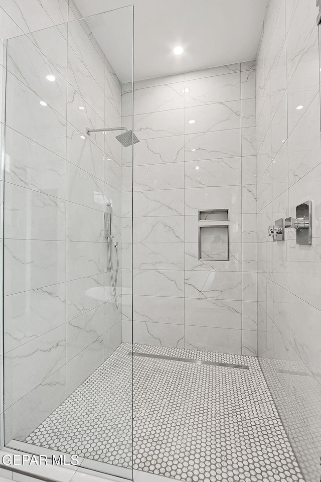 bathroom with tiled shower