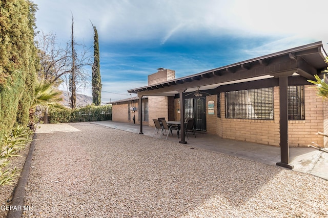 rear view of house featuring a patio and ceiling fan