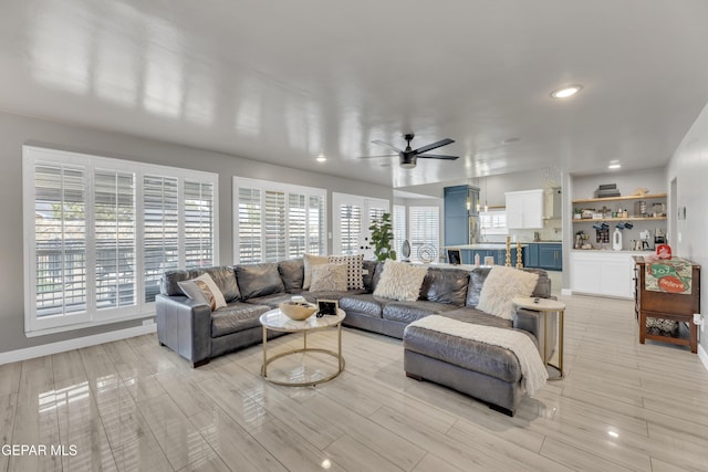 living room with plenty of natural light and ceiling fan