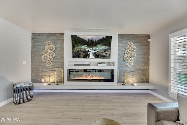 living room featuring built in shelves and light wood-type flooring