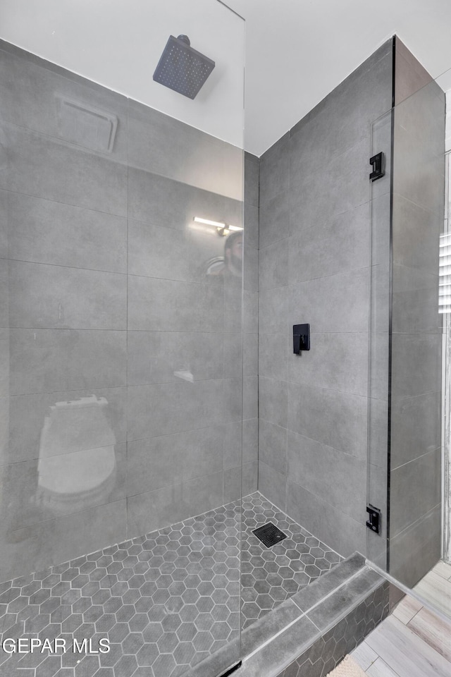 bathroom with a shower with shower door