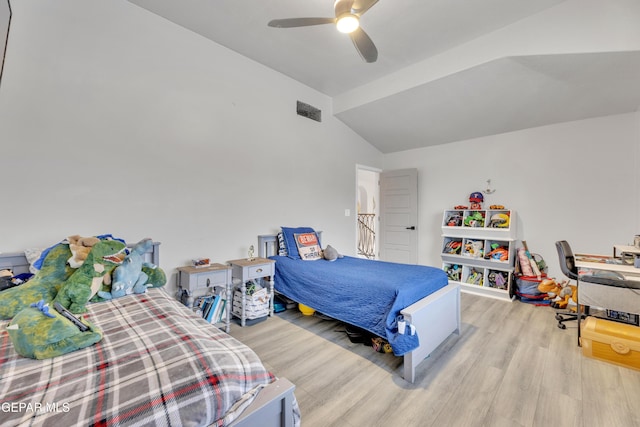 bedroom with ceiling fan, lofted ceiling, and light wood-type flooring