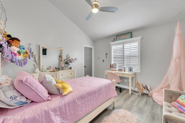 bedroom with ceiling fan, lofted ceiling, and light hardwood / wood-style flooring