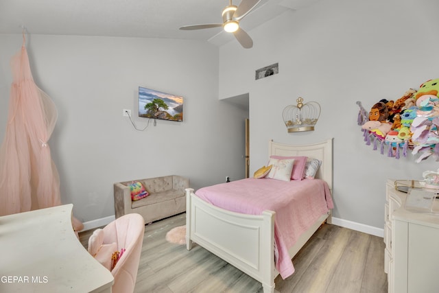 bedroom featuring ceiling fan, lofted ceiling, and light hardwood / wood-style flooring