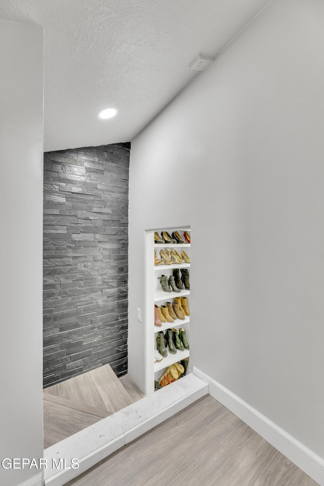 interior space featuring hardwood / wood-style floors and a textured ceiling