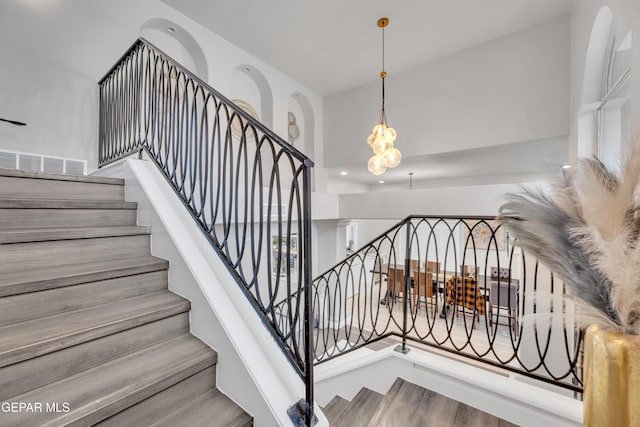 staircase featuring a high ceiling