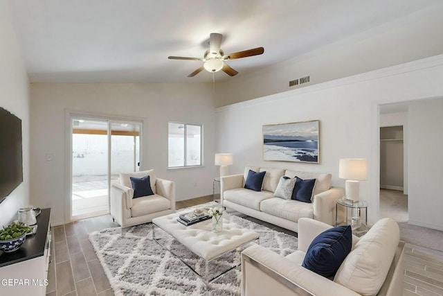 living room with ceiling fan, lofted ceiling, and hardwood / wood-style floors