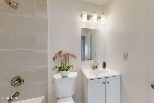 full bathroom featuring tiled shower / bath combo, vanity, and toilet