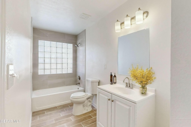 full bathroom with vanity, toilet, and tiled shower / bath combo