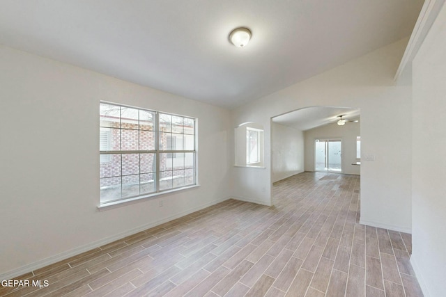 unfurnished room featuring ceiling fan and lofted ceiling