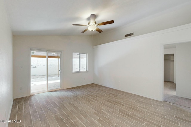 empty room with vaulted ceiling and ceiling fan