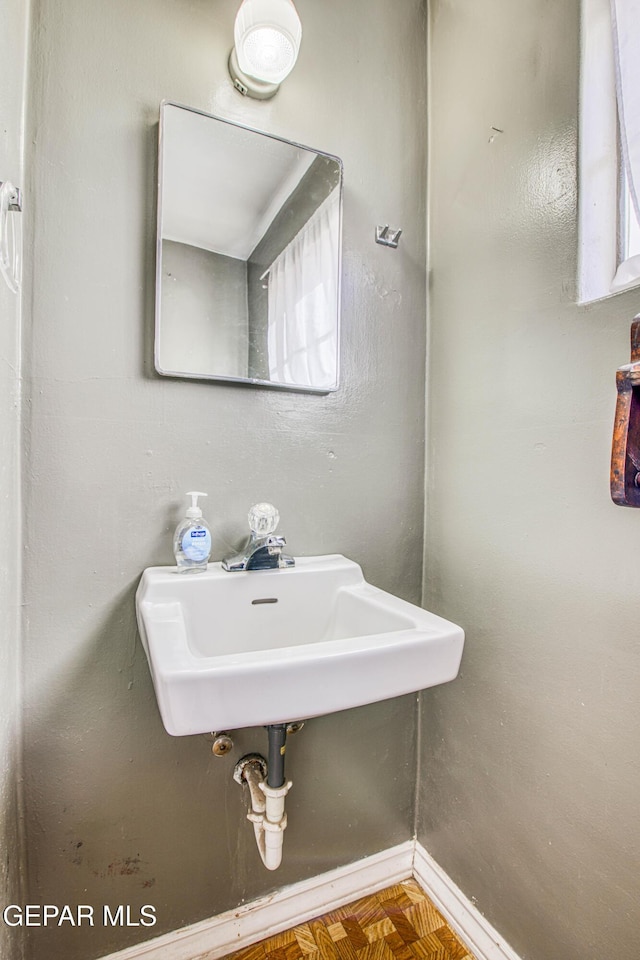 bathroom with parquet floors and sink