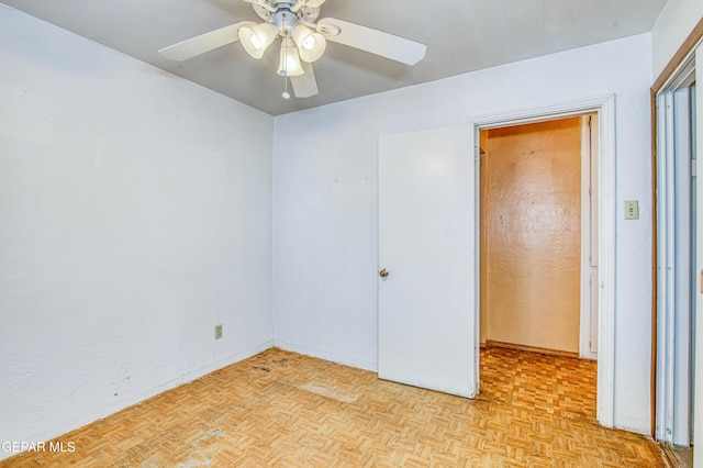 unfurnished room featuring ceiling fan and light parquet floors