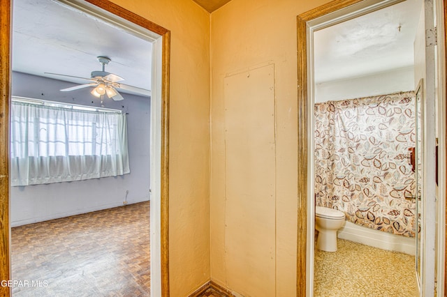 bathroom with ceiling fan and toilet