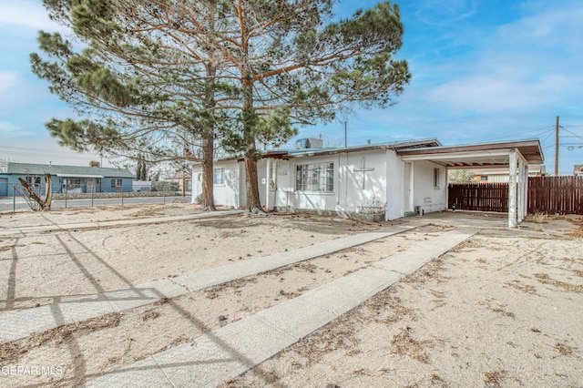 ranch-style home with a carport