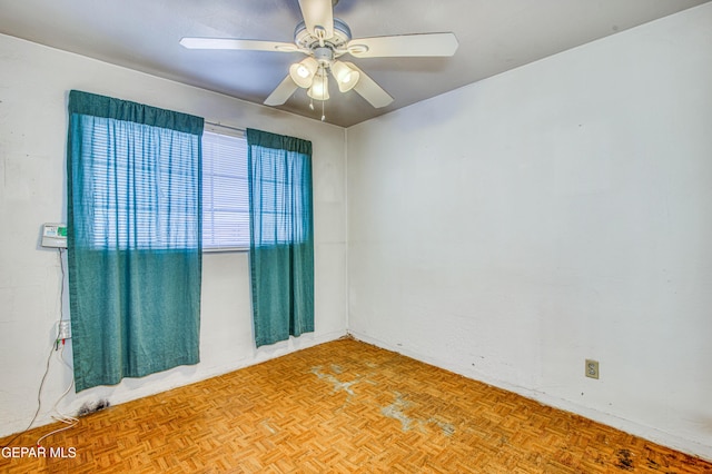 spare room featuring light parquet flooring and ceiling fan