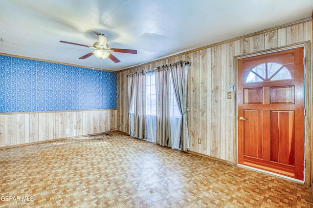 foyer with light parquet floors, a textured ceiling, and ceiling fan