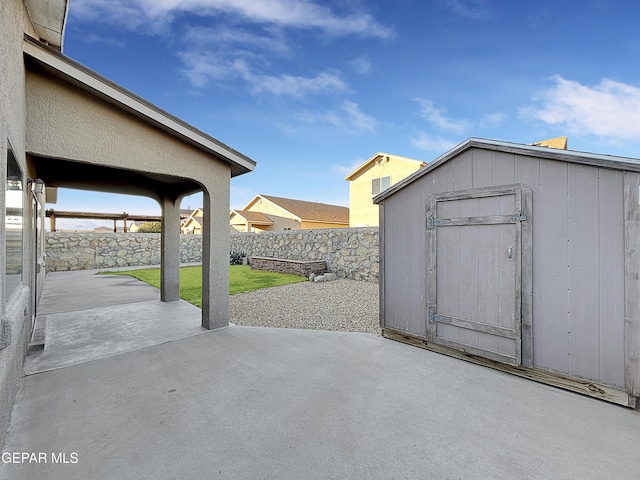 view of patio with a storage unit