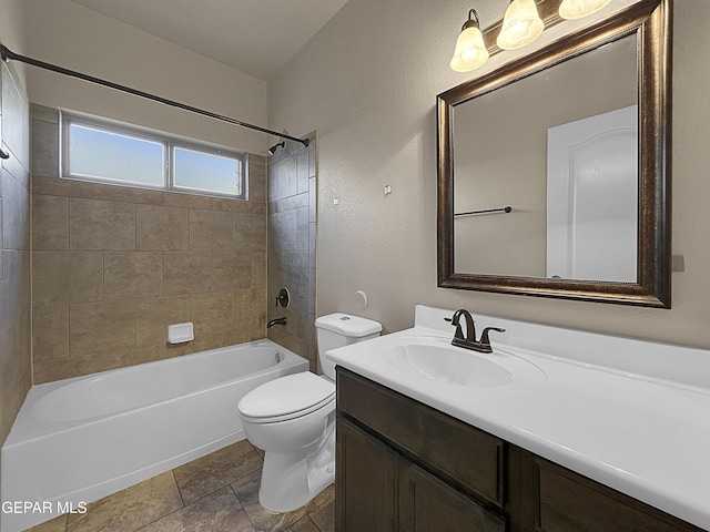 full bathroom featuring tiled shower / bath, vanity, toilet, and tile patterned flooring