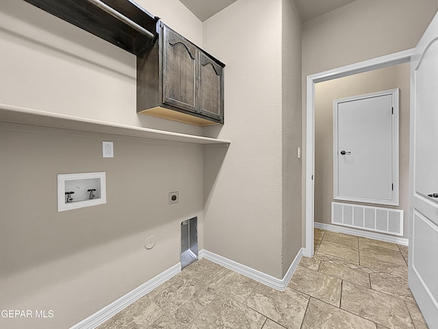 clothes washing area with hookup for a washing machine, gas dryer hookup, hookup for an electric dryer, and cabinets