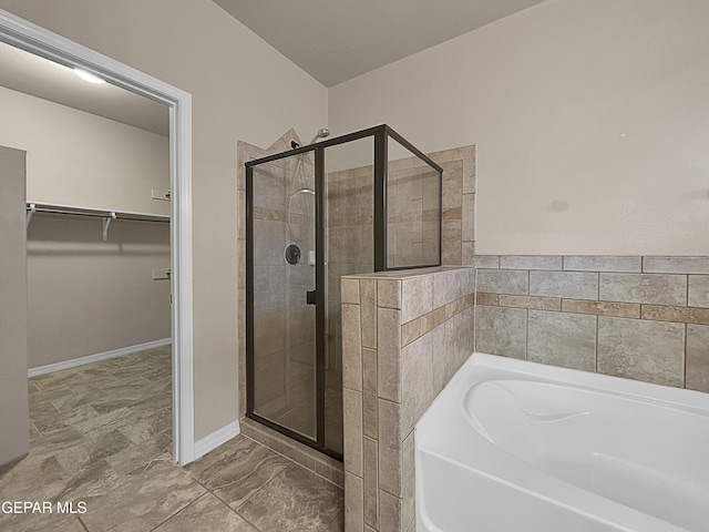 bathroom featuring independent shower and bath