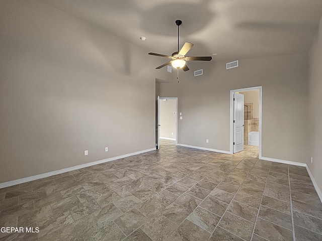 empty room featuring high vaulted ceiling and ceiling fan