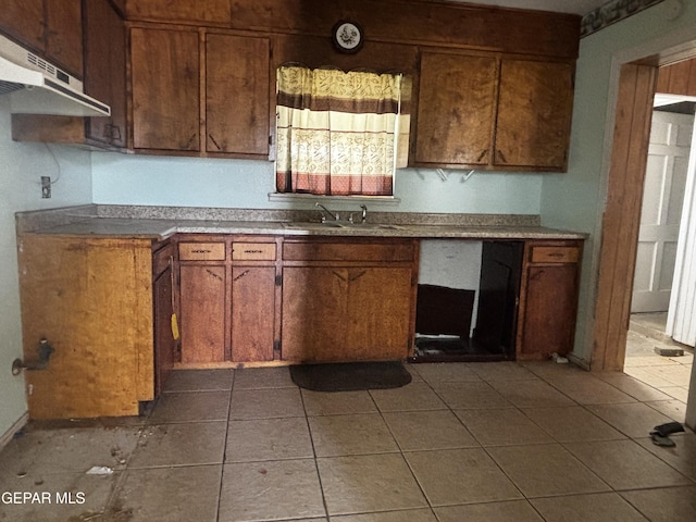 kitchen with sink and dark tile patterned flooring