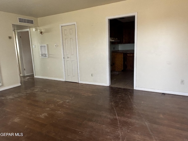 spare room with dark hardwood / wood-style floors