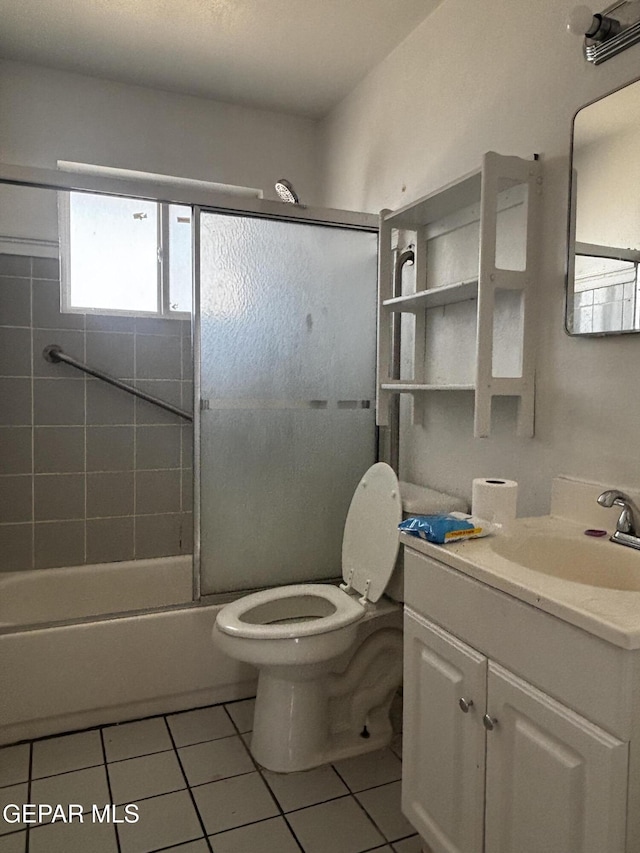 full bathroom featuring vanity, tile patterned floors, shower / bath combination with glass door, and toilet