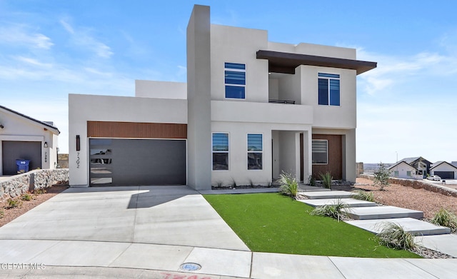 modern home featuring a garage and a front lawn