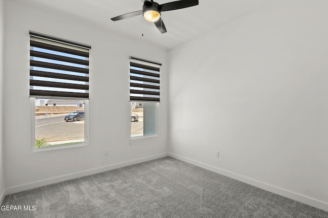 carpeted spare room featuring ceiling fan