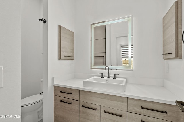 bathroom with vanity and toilet